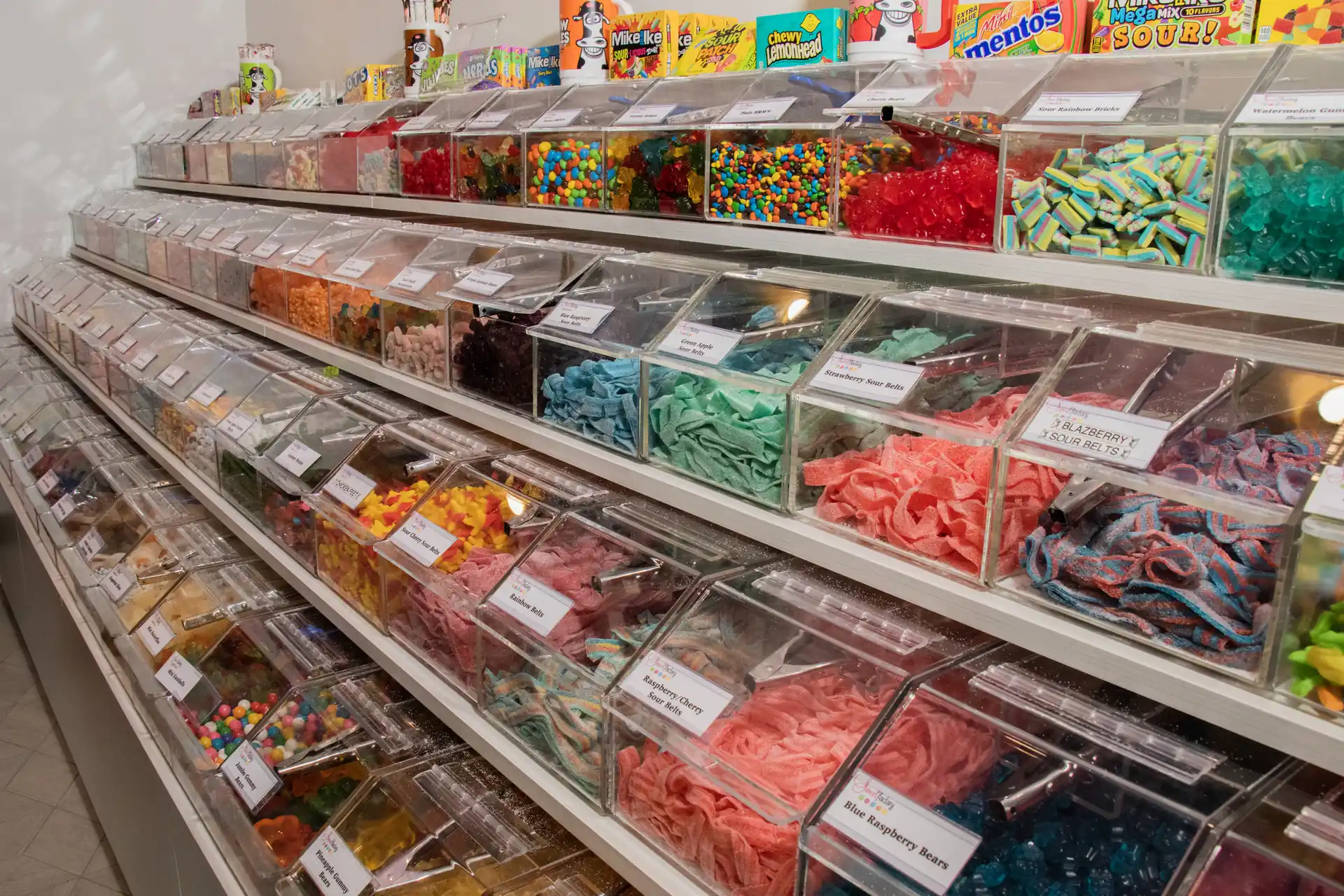 Full candy wall with boxed candy on top shelf at Sweet Factory, Somerset Mall