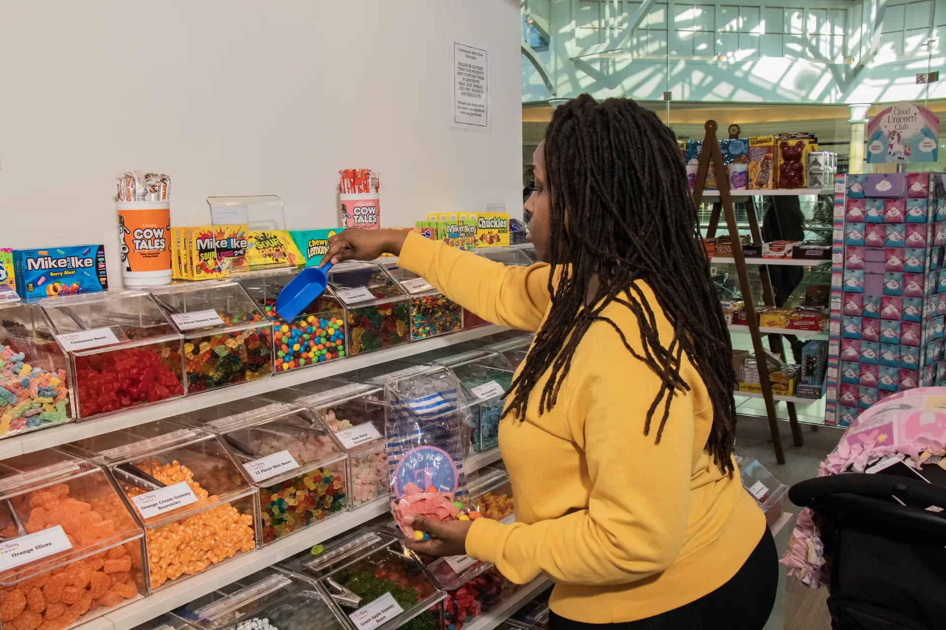 Team member scooping candy at Sweet Factory, Somerset Mall, Troy Michigan